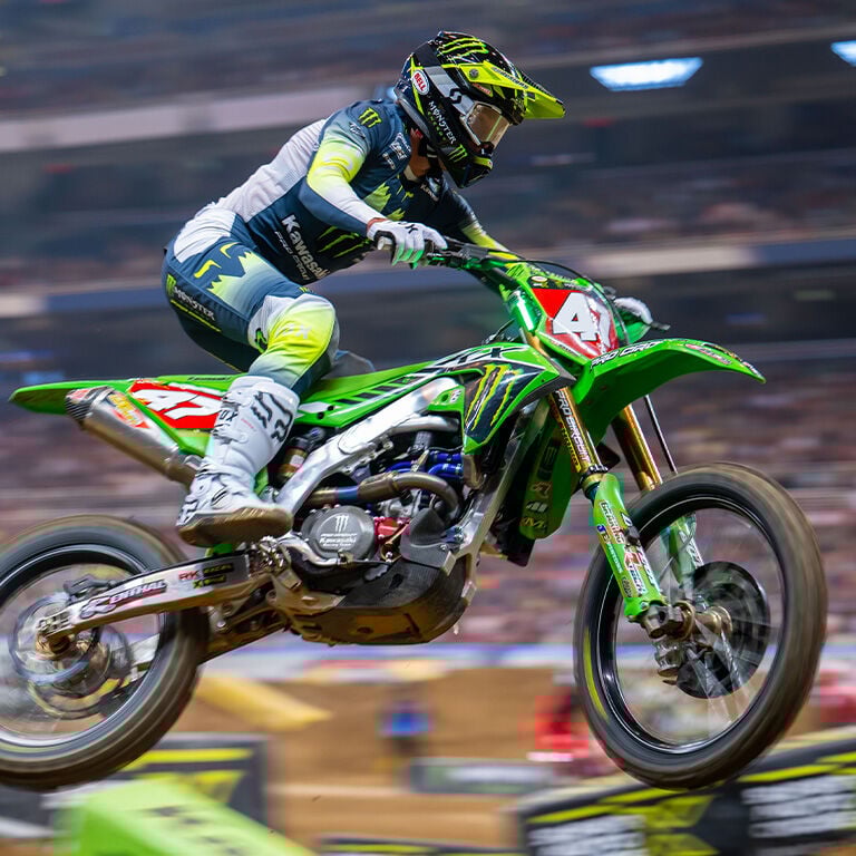 Rider in the air on a mx racetrack with Fox x Kawasaki Gear