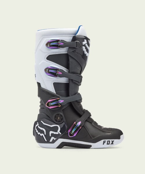 Black motocross boot on green background