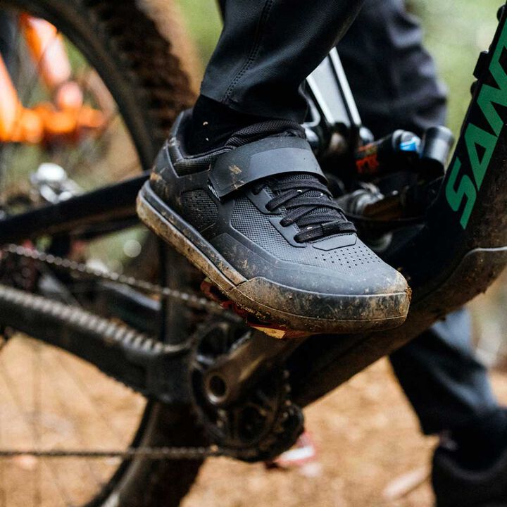 Closeup of mountain bike shoe pedaling on bike.