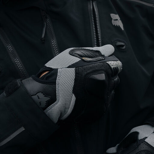 gloved hand zipping up an adv jacket