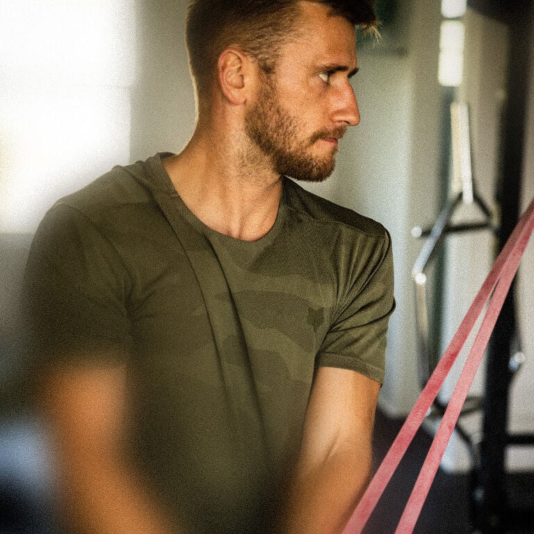 Man at the gym wearing a black training shirt.