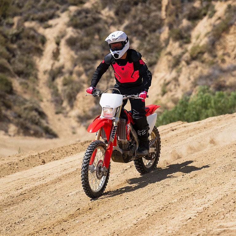 woman riding in 180 mx gear