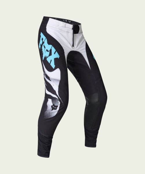 black moto pants on green background