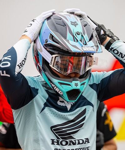 Person wearing Fox jersey, helmet and goggles