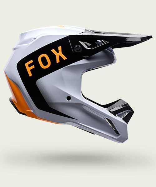 white, black and orange v1 helmet on green background